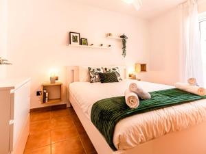 a bedroom with a bed with two towels on it at Renteando Albir Apartments in Albir +24 photos