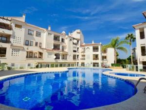 a large swimming pool in front of a building at Renteando Albir Apartments in Albir
