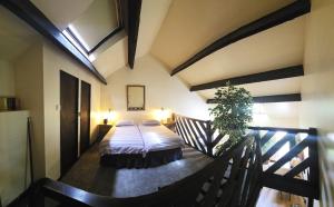 a bedroom with a bed on a balcony at Langford Apartment and Rooms in Bristol
