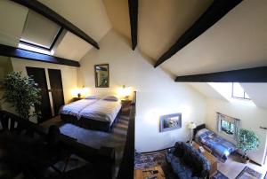 a bedroom with a bed and a living room at Langford Apartment and Rooms in Bristol
