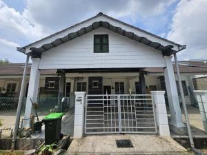 a house with a gate in front of it at Razumi's Homestay 3 in Arau