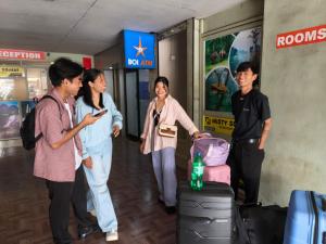 a group of people standing in an airport with luggage at Misty Square Residency in Kalpetta