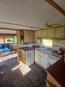 a kitchen with white cabinets and a counter top at DanowskieCamp in Danowskie