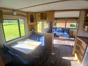 a living room with a table and chairs in a van at DanowskieCamp in Danowskie