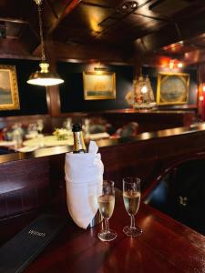 a bottle of champagne and two glasses on a bar at Hotel Kalliohovi - ilmastoidut huoneet - in Rauma +18 photos