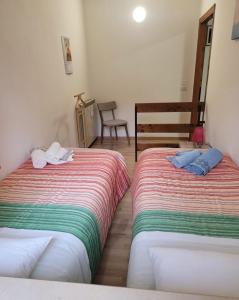 a room with two beds and a chair at ALBACHIARA in Ramazzano