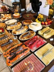 a table topped with lots of different types of food at Don Marcos Hotel com Pizzaria in Guarujá