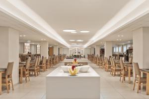 a row of tables and chairs in a cafeteria at Hotel Best Oasis Park in Salou