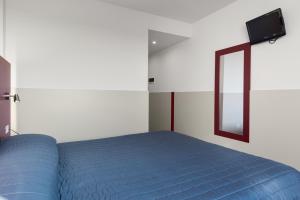 Posteľ alebo postele v izbe v ubytovaní Hotel Porta Palio