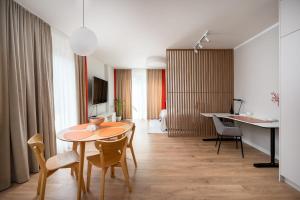 a dining room with a table and chairs in a room at Unique Tower Business View Apartment in Warsaw