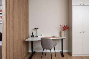 an office with a desk and a chair in a room at Unique Tower Business View Apartment in Warsaw