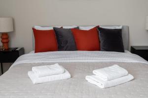two stacks of towels sitting on top of a bed at Unique Tower Business View Apartment in Warsaw +20 photos