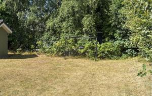 a soccer goal in a yard with trees at Nice Home In Grenaa With Sauna in Grenå