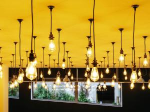 a bunch of lights hanging from a ceiling at ibis Styles Limoges Centre in Limoges