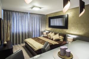 a bedroom with a bed and a table in it at Luxury Apartments Ostrava in Ostrava