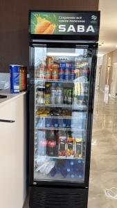 a refrigerator filled with lots of drinks and drinks at Meridian Hotel in Georgīevka