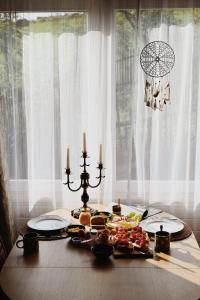 a table with candles and food on top of it at Domek na wyłączność w Otulinie Ojcowskiego Parku Narodowego in Wola Kalinowska +25 photos