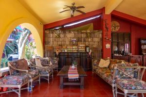 a living room with couches and a table at Collection O Casa Bella Hotel Boutique, Cabo San Lucas in Cabo San Lucas