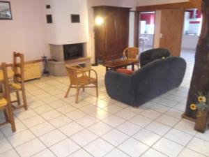 a living room with couches and chairs and a fireplace at Gite le Sauceley Maison de vacances pour 6 à 10 personnes in Girmont-Val-dʼAjol