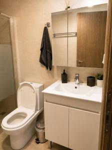 a bathroom with a white toilet and a sink at Clio's house in Áyioi Dhéka +20 photos