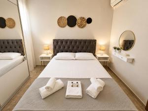 a bedroom with a large bed with towels on it at Clio's house in Áyioi Dhéka