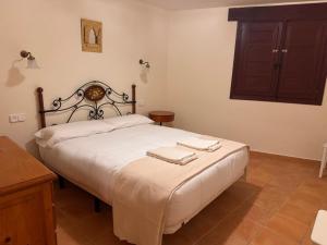 a bedroom with a bed with two towels on it at Casa Rural Villa Kora in El Burgo de Osma