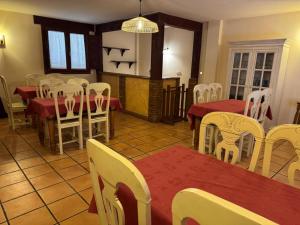 a dining room with white chairs and tables and tablesktop at Casa Rural Villa Kora in El Burgo de Osma +19 photos