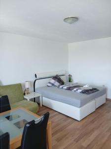 a bedroom with a bed and a couch and a table at B1011, gemütliches Appartement mit Ausblick in Lahnstein