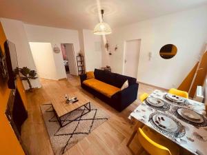 a living room with a couch and a table at Le Ch'ti Cambrai,Élégant, Centre ville in Cambrai