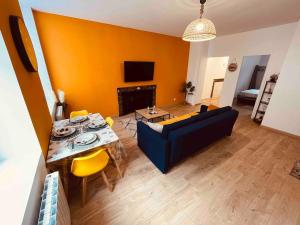 a living room with a blue couch and a table at Le Ch'ti Cambrai,Élégant, Centre ville in Cambrai +22 photos