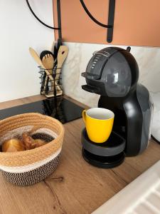 a coffee maker on a counter next to a basket of food at L'Escale de Gaston in Sainte-Florence