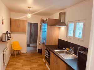 a kitchen with a sink and a counter top at Le Ch'ti Cambrai,Élégant, Centre ville in Cambrai