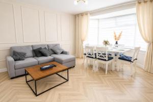 a living room with a couch and a table at Stylish 2BR House Parking & WiFi Sleeps 6 in Grangemouth