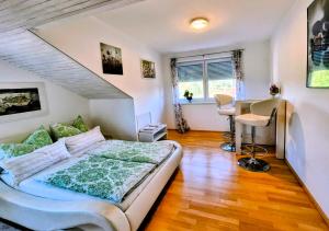 a bedroom with a bed and a desk in it at Ferienwohnung Pickenhan in Scheidegg
