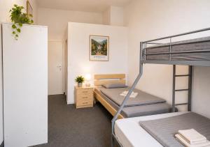 a bedroom with two bunk beds and a desk at Ermar Gästehaus in Baden-Baden