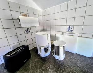 a small bathroom with two toilets and a sink at Ferienwohnung Pickenhan in Scheidegg +71 photos