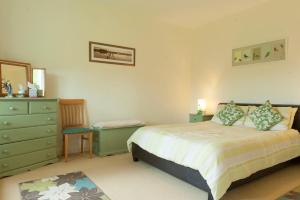 a bedroom with a bed and a dresser in it at Nick & Sandra's in Slane