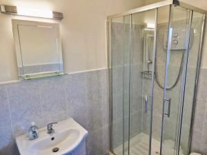 a bathroom with a glass shower and a sink at Nick & Sandra's in Slane
