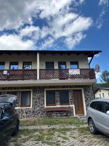 a house with cars parked in front of it at Apartmán PT Donovaly in Donovaly