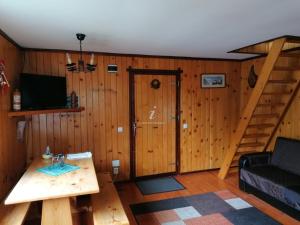a living room with a staircase and a couch and a table at Casa Riciu in Buşteni