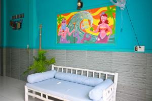 a white couch in a room with a painting at Gió Home Nhon Ly in Quy Nhon