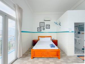 a small bedroom with a bed and a sink at Gió Home Nhon Ly in Quy Nhon +24 photos