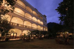 a large building with chairs in front of it at Atulya Niwas in Udaipur