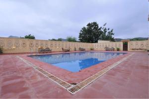 a swimming pool in the middle of a building at Atulya Niwas in Udaipur