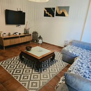 a living room with a couch and a coffee table at Casa Rural El Jaral in Orihuela del Tremedal