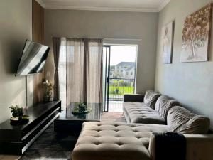 a living room with a large couch and a large window at Ocean view in Johannesburg