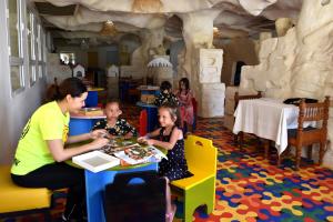 a group of children sitting at a table in a restaurant at LAICO Hammamet hotel in Hammamet