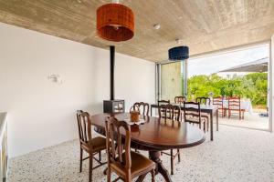 a dining room with a wooden table and chairs at Monte Garcia Nunes in Coruche