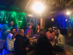 a group of people sitting around a table in a bar at Cindrella Sky Nest Camp Ella in Ella