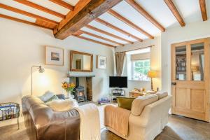 a living room with a couch and a fireplace at 3 Bed in Askrigg oc-ds779 in Askrigg